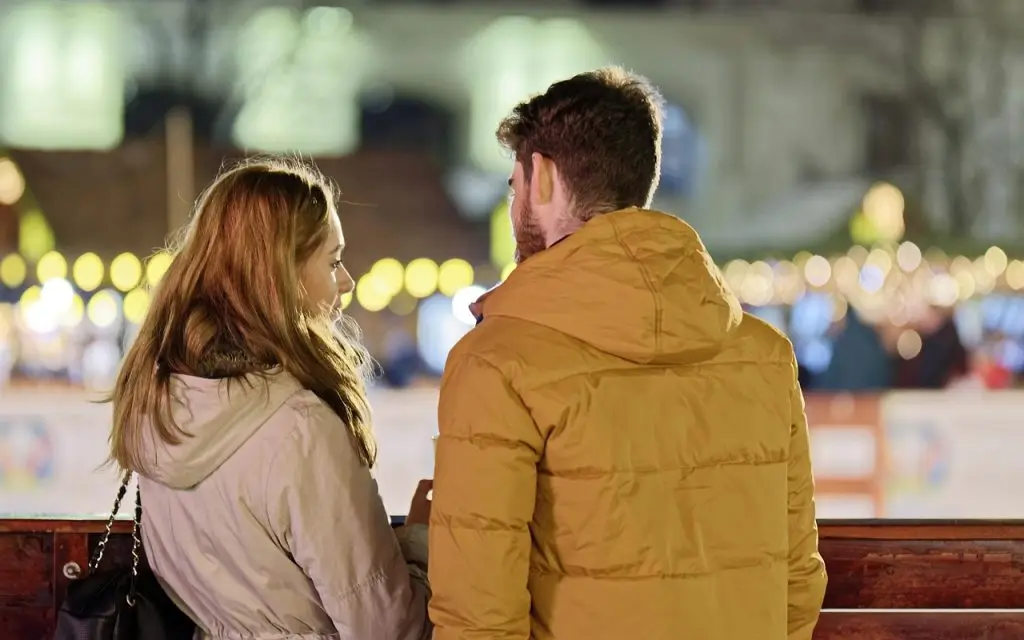 merry christmas, couple, young people, people, blonde, friendship, together, talking, fence, winter, holiday, lights, ornaments, decoration, back view, snapshot